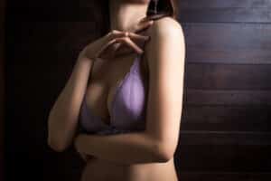 Woman in purple bra with shapely breasts from breast augmentation